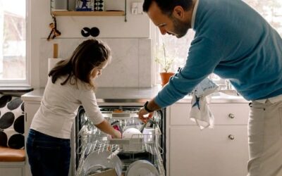 Father-daughter-arranging-utensils-dishwasher-
